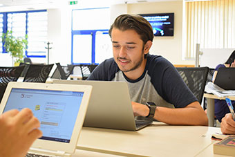 A student working on a desk in IT Services open access area