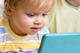Parent with child reading on a tablet