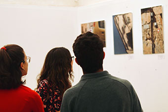 Three students at an Art exhibition