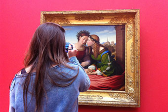 Female student photographing Art