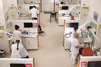 Students separate in different clinic cubicles