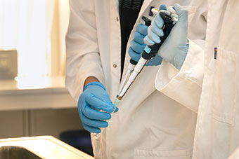 A laboratory employee using lab equipment