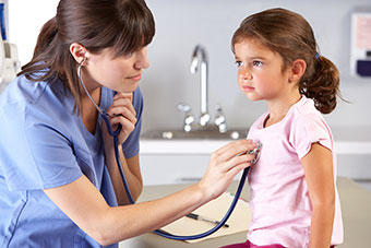 A female doctor examining a child