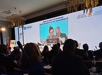 Conference session in progress - speakers and audience