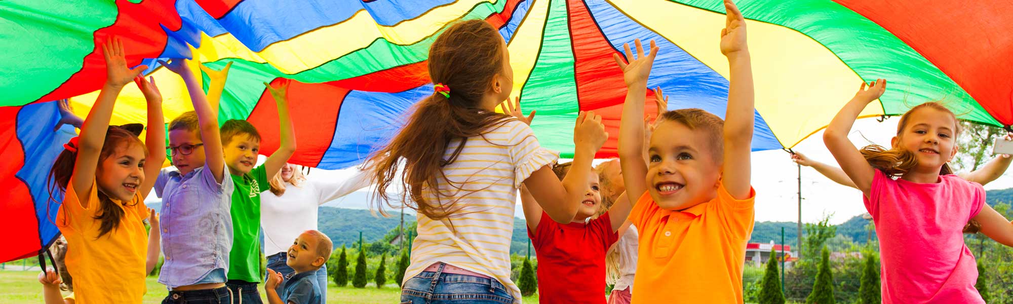 Laughing children playing outdoors in the summer