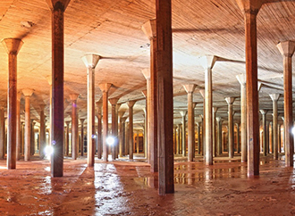 An industrial heritage setting made up of antique vertical pipes inside a building
