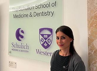 A lecture in progress and a person in front of a plaque