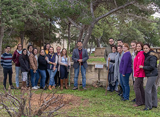 Faculty for Social Wellbeing staff and students planting trees on campus