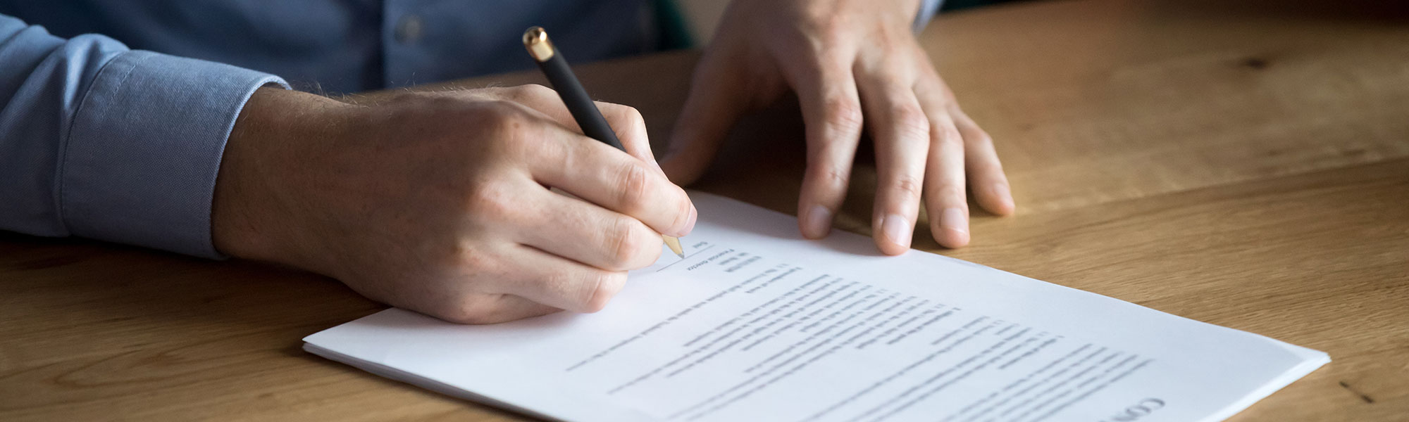 A person at a desk; contract on desk