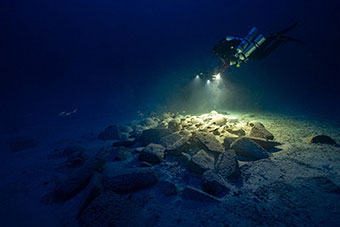 Diver exploring archaeological remains under-water