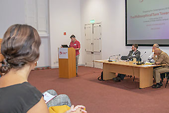 Conference session in progress - speakers and audience