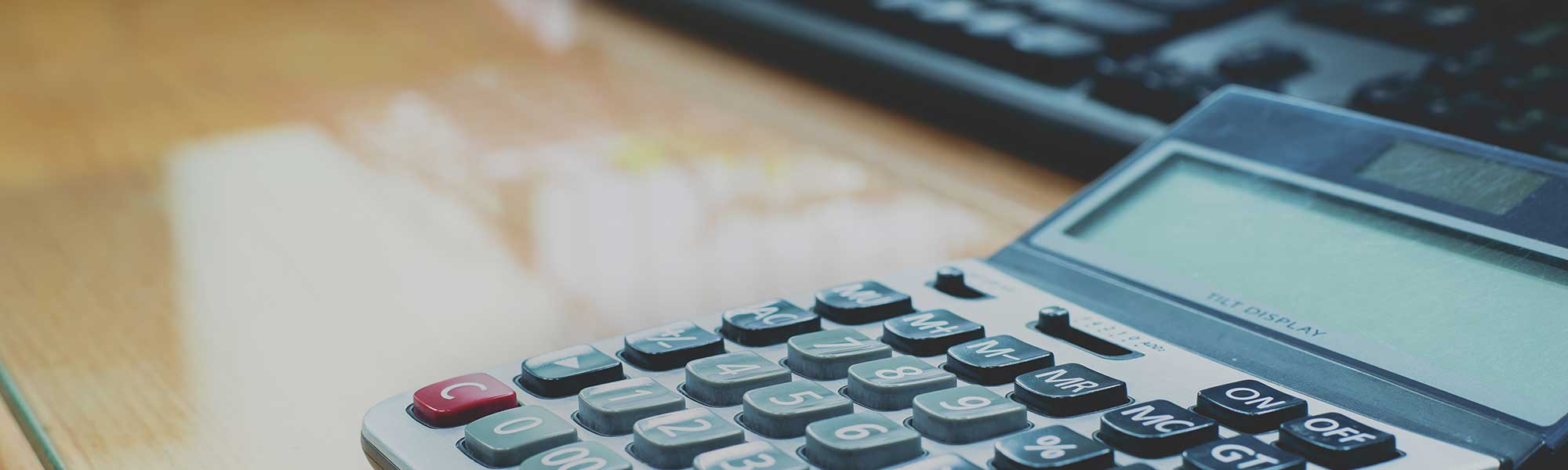 Calculator and keyboard on desk