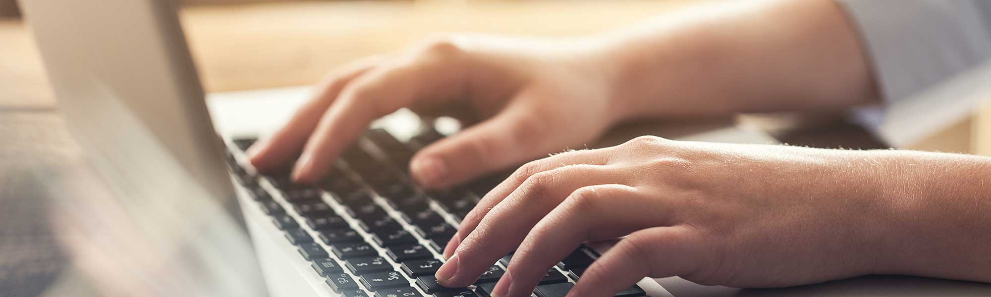 Woman typing at a computer