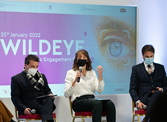 Three people on stage during a discussion
