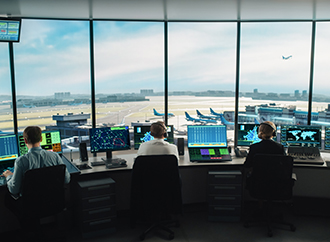 Diverse Air Traffic Control Team Working in a Modern Airport Tower. Office Room is Full of Desktop Computer Displays with Navigation Screens, Airplane Flight Radar Data for Controllers.