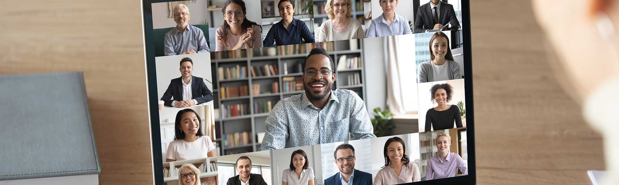 Back view of female employee speak talk on video call with diverse multiracial colleagues on online event briefing, woman worker have Webcam group conference with coworkers on modern laptop at home