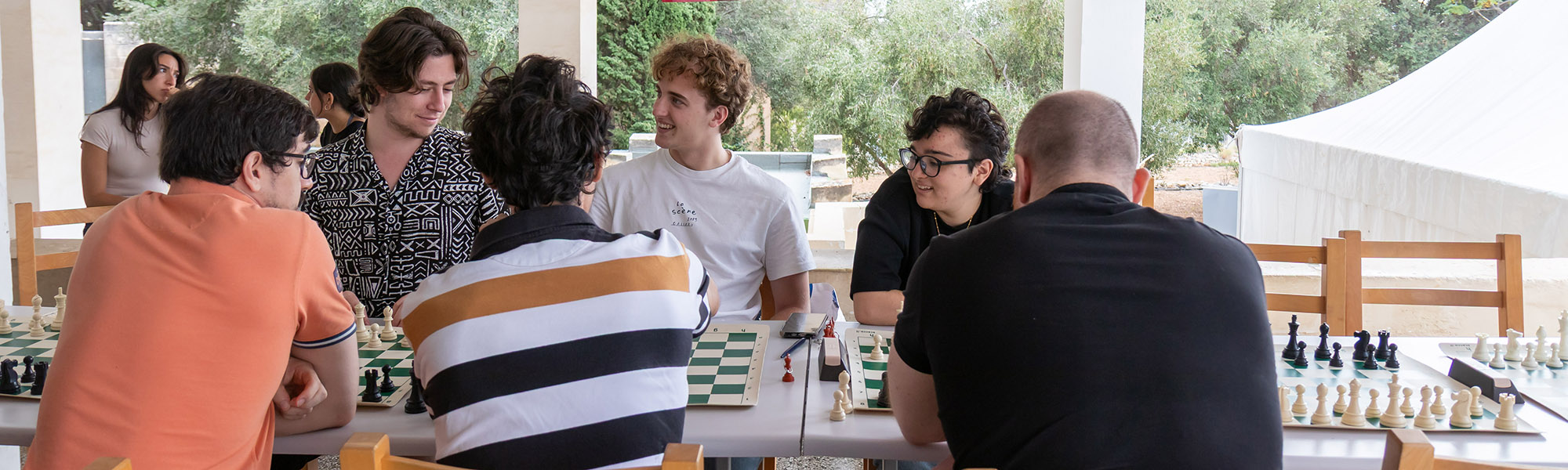 Students playing chess at the Library outside area