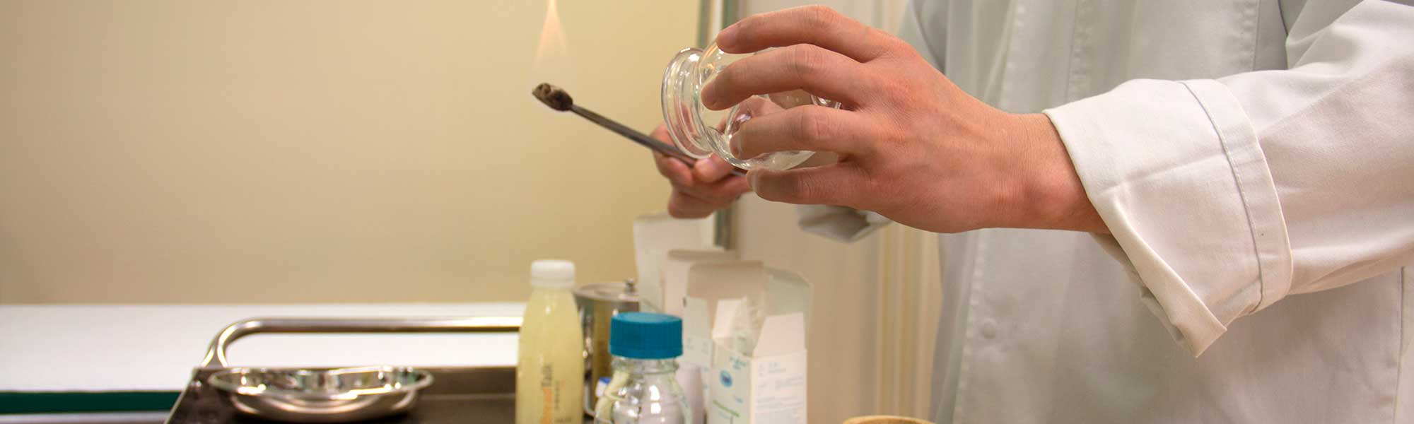 TCM doctor heating a cupping utensil