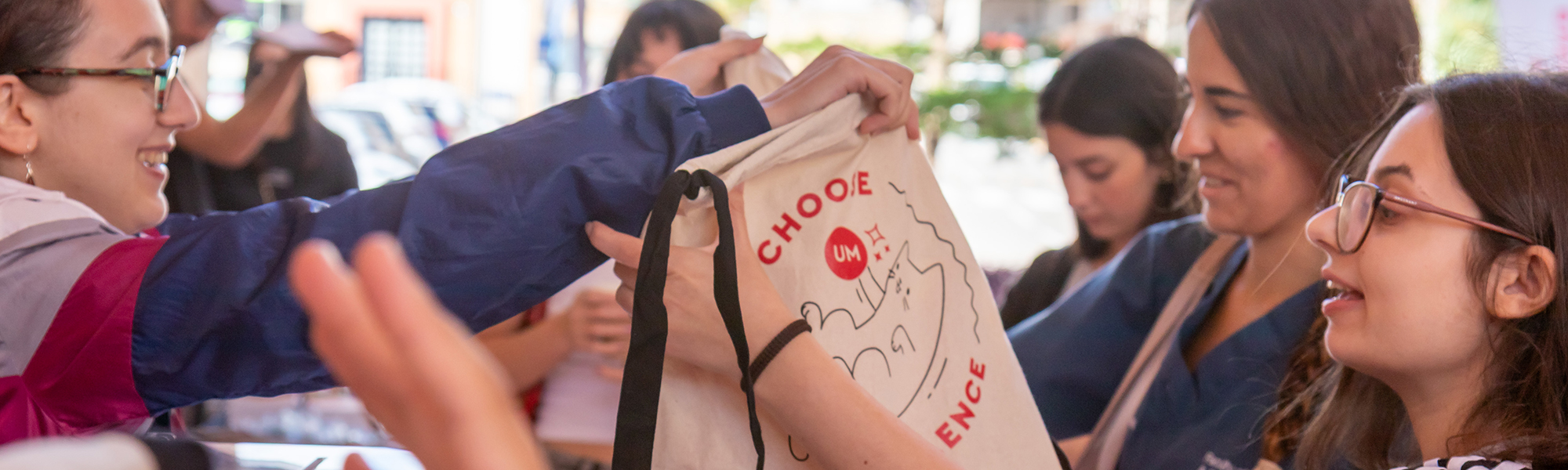Freshers Week 2025 - distributing UM tote bags at the Marketing, Communications and Alumni Office stand at the Gateway Building