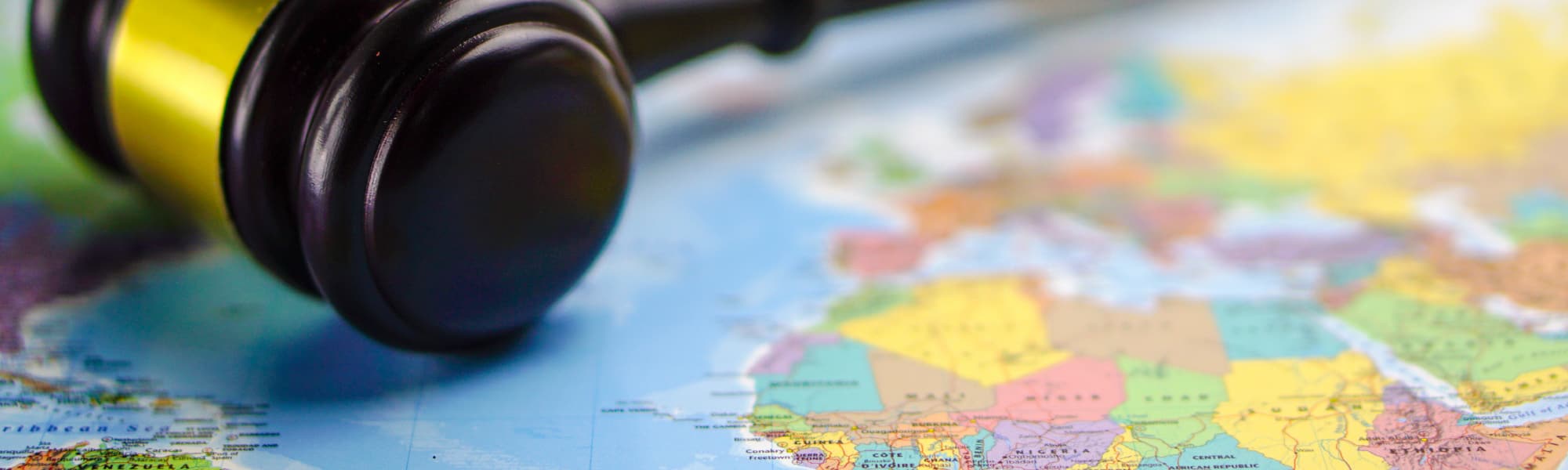 A photo showing a gavel and world map