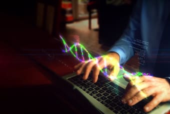 A detail of a person typing on a laptop