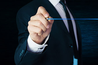 photo of man in suit writing on white board