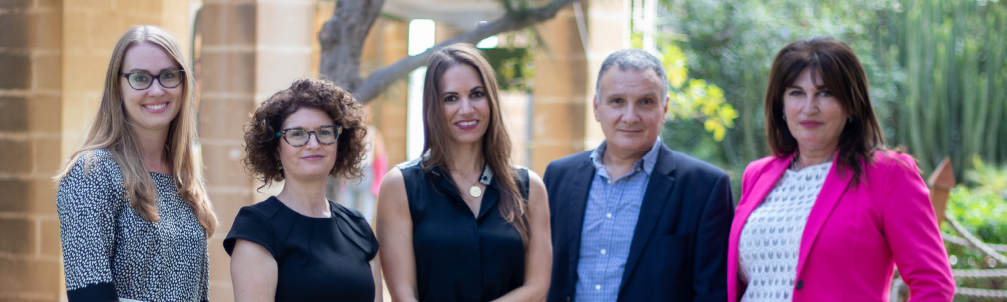 academic staff members standing next to each other in Japanese garden