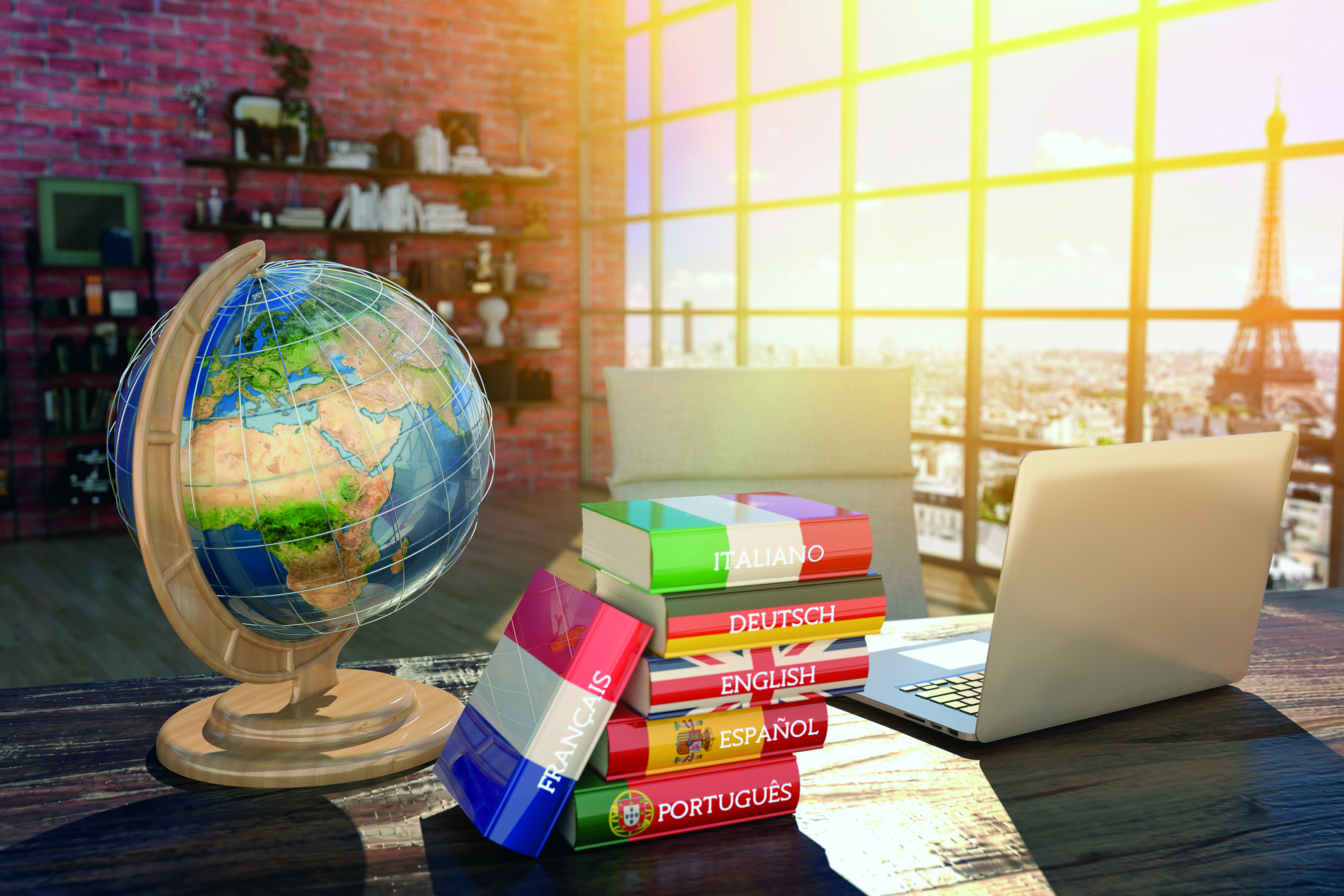 A globe and dictionaries on a desk. A huge window in the background letting in sunlight.