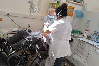 A dentist working on a patient in the dental clinic