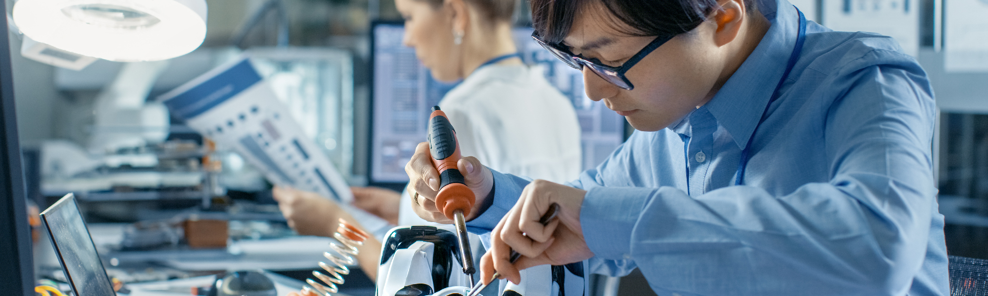 Student soldering and working on a project