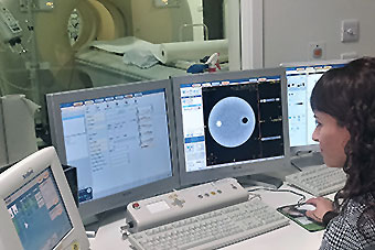 A practitioner looking at test results on a monitor