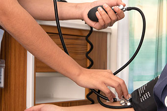 A nursing taking blood pressure