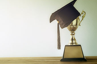 Graduation cap and trophy