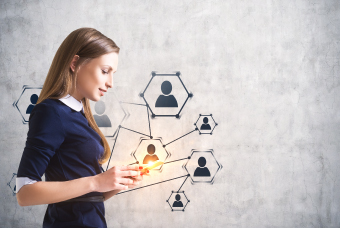 A woman in front of an organisation diagram