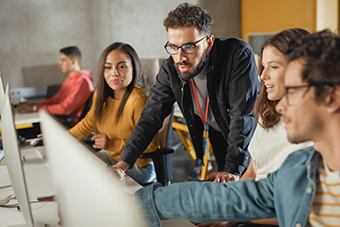 Lecturer helps students with Project, advising on their work.