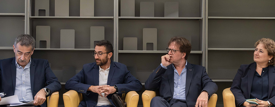 Four persons listening during a discussion