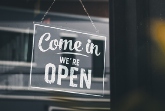 Come in were open sign hanging on a black door