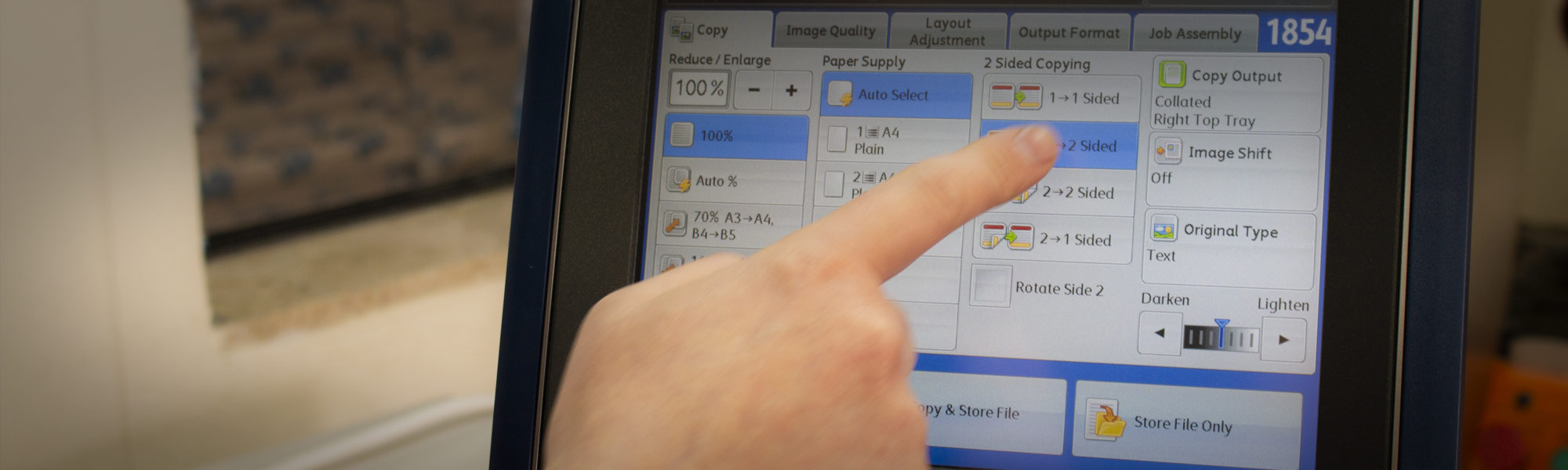 A person selecting printing options from a screen