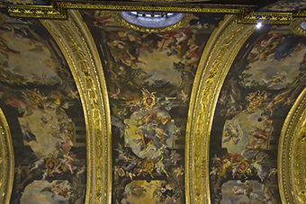 The inside of a church dome adorned with paintings